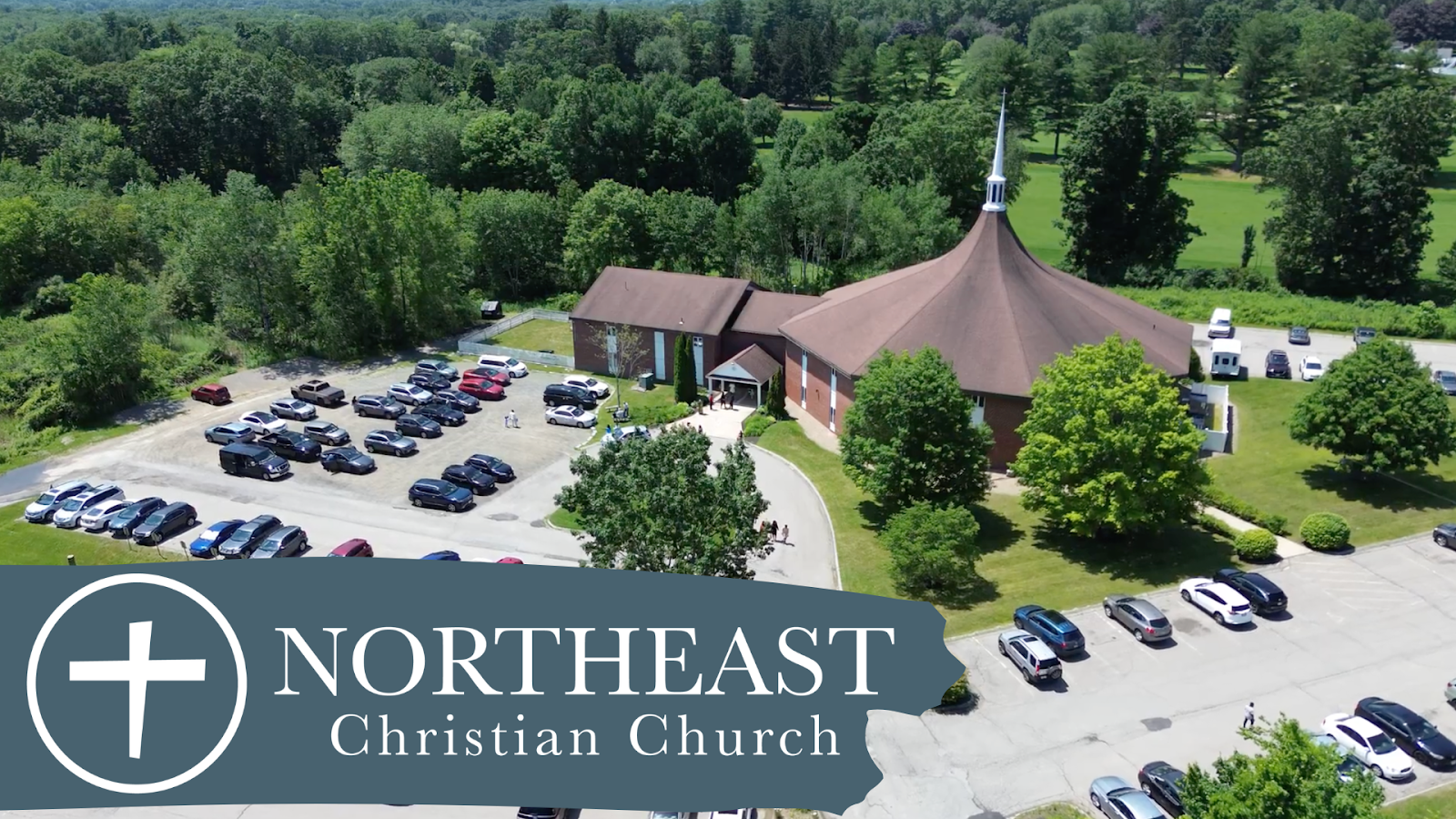 Aerial view of the Northeast Christian Church building and parking lot in Tewksbury, MA