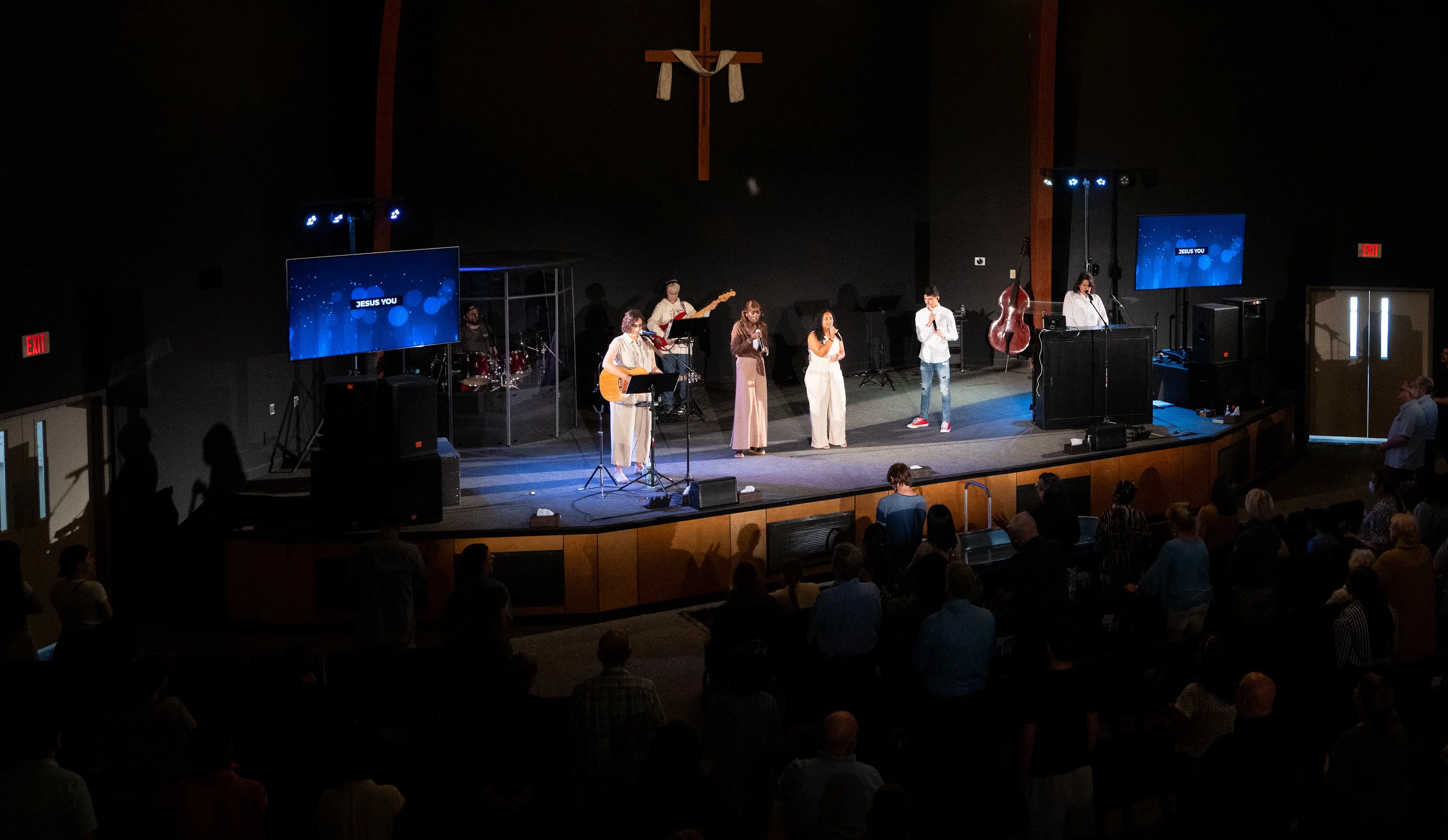 Sunday worship at Northeast Christian Church, string lights above the stage and cross