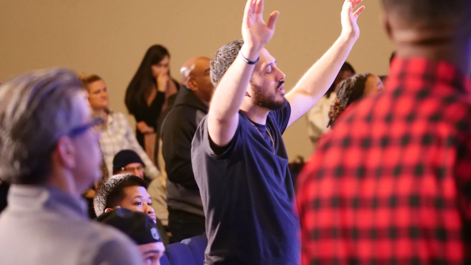 Congregation worshipping with raised hands at Northeast Christian Church